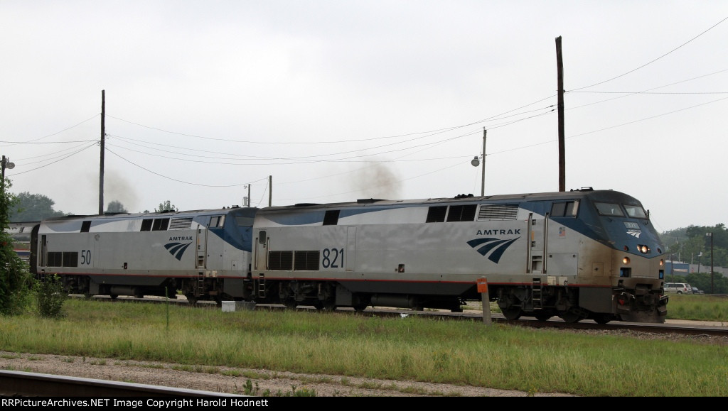 AMTK 821 leads train P092 away from the station